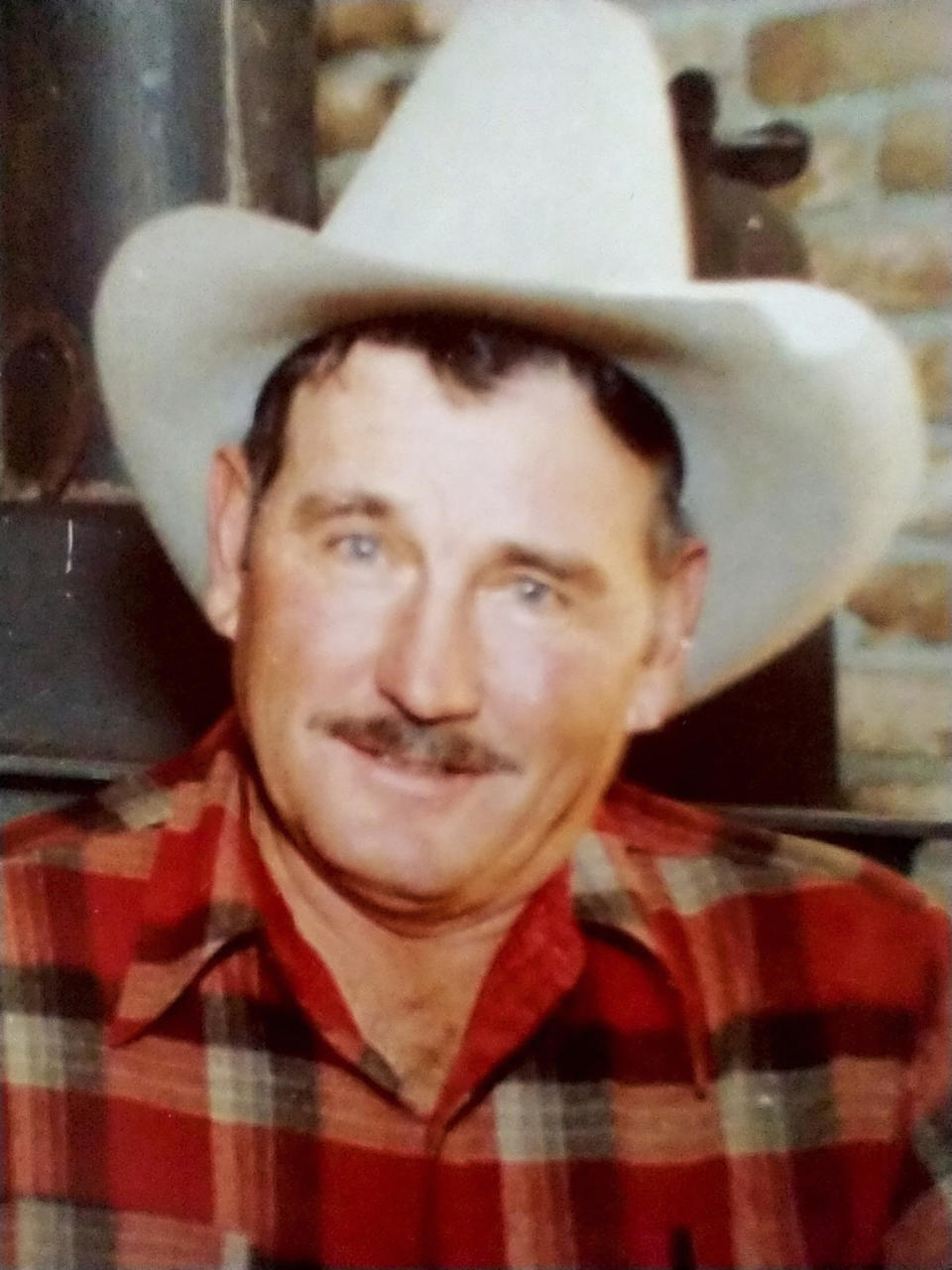 This family photo provided by Brett Woolley shows his father, Dan Woolley, in the fall of 1978 at the family's home on a ranch near Clayton, Idaho. In September 1980, Brett Woolley's dad was shot in the parking lot of a small town bar deep in the Idaho mountains. Then the shooter crossed the street to the only other bar in town, ordered a drink and declared, "I just killed a man," and disappeared into the night. As days turned into years, Woolley accepted the likelihood that his father's murderer would never be found. But all that changed in the fall of 2019 when authorities arrested a former pro rodeo rider named Water Mason in a small Texas village. (Courtesy of Brett Woolley via AP)