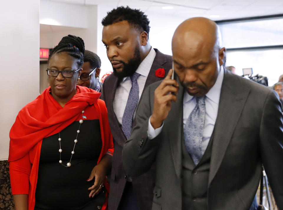 Allison Jean, left, mother of Botham Jean, and attorneys Lee Merritt, center, and Daryl Washington, right, leave court as the jury begins deliberation on how to sentence former Dallas police officer Amber Guyger at Frank Crowley Court Building in Dallas, Wednesday, Oct. 2, 2019. (AP Photo/Tony Gutierrez)