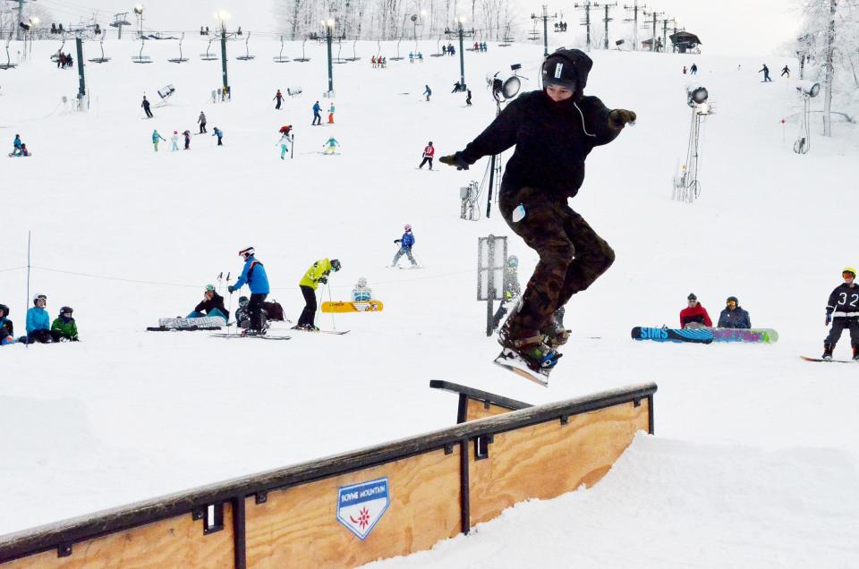 A snowboarder is airborne during a Rail Jam competition at Boyne Mountain.