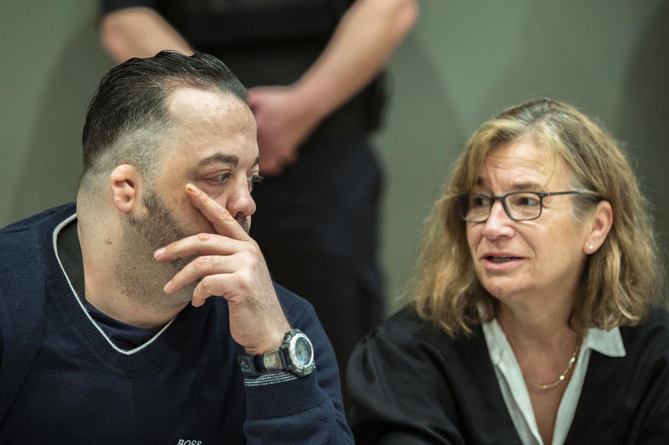 Former nurse Niels Hoegel, left, accused of multiple murder and attempted murder of patients, talks to his lawyer Ulrike Baumann, right, during a session of the district court in Oldenburg, Germany, Wednesday, June 5, 2019. (Mohssen Assanimoghaddam/dpa via AP, Pool)