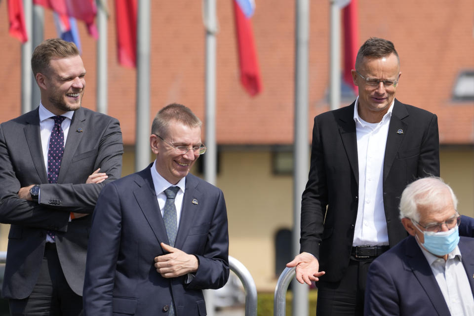 From left, Lithuania's Foreign Minister Gabrielius Landsbergis, Latvia's Foreign Minister Edgars Rinkevics, Hungary's Foreign Minister Peter Szijjarto and European Union foreign policy chief Josep Borrell pose at a group photo during a meeting of EU foreign ministers at the Brdo Congress Center in Kranj, Slovenia, Friday, Sept. 3, 2021. European Union officials listed Friday a set of conditions to the Taliban including the respect of human rights and rule of law that should define the level of engagement the 27-nation bloc will develop with the new Afghanistan rulers. (AP Photo/Darko Bandic)