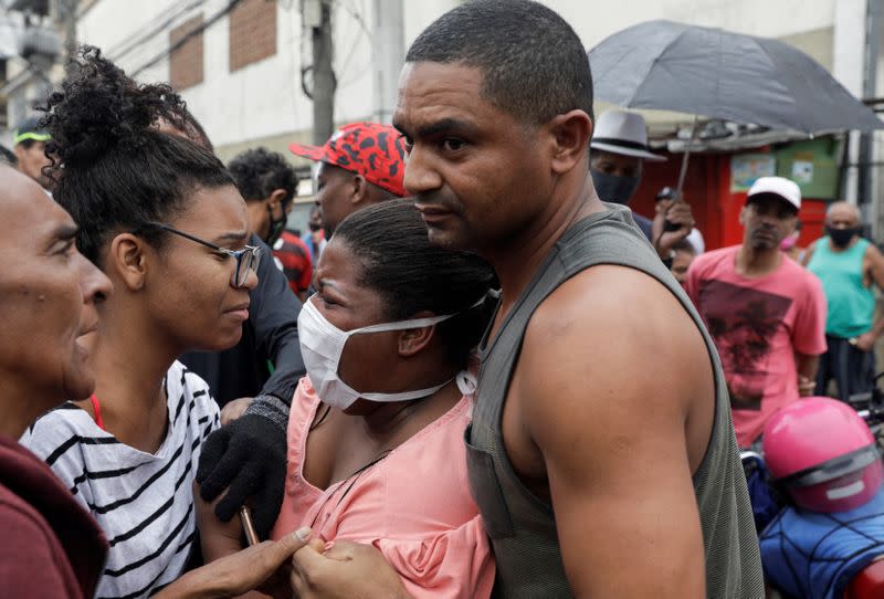 Residents react after a police operation against drug gangs in Rio de Janeiro