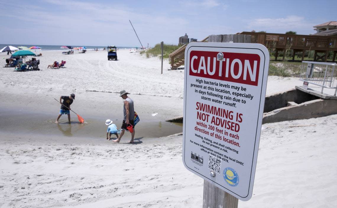 Children play in the Cane Patch Swash in Myrtle Beach. DHEC warns against swimming in swashes and in the outflow of storm water pipes. Long-term swim advisory signs are placed in many areas along the Myrtle Beach coast. June 28, 2018.