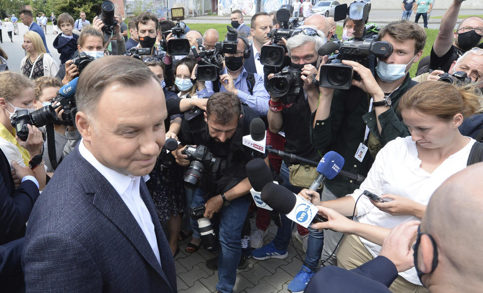 Candidate in Poland's tight presidential election runoff, incumbent President Andrzej Duda talks to reporters after having cast his ballot at a polling station in his hometown of Krakow, Poland, on Sunday, July 12, 2020. Conservative Duda is running against liberal Warsaw Mayor Rafal Trzaskowski and latest opinion polls suggest the race will be decided by a very narrow margin.(AP Photo/Czarek Sokolowski)
