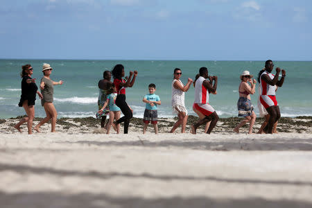 Tourists exercise at the beach in Varadero, Cuba, December 7, 2018. Picture taken December 7, 2018. REUTERS/Fernando Medina