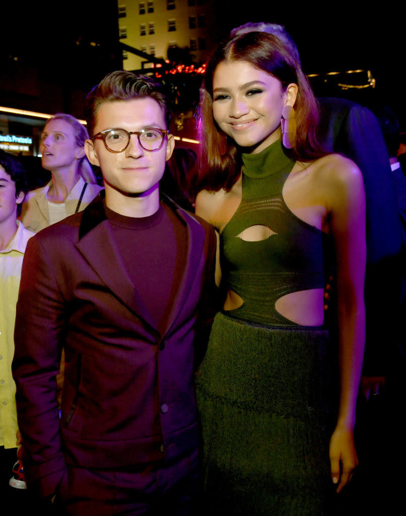 Tom poses for a photo inside an event with Zendaya