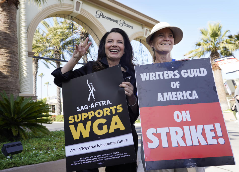 Fran Drescher, left, president of SAG-AFTRA, and Meredith Stiehm, president of Writers Guild of America West, pose together during a rally by striking writers outside Paramount Pictures studio, Monday, May 8, 2023, in Los Angeles. (AP Photo/Chris Pizzello)