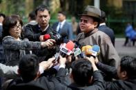 Mongolian President Tsakhiagiin Elbegdorj (C) speaks to the media after casting his vote for the parliamentary elections at a polling station in Ulaanbaatar, Mongolia, June 29, 2016. REUTERS/Jason Lee