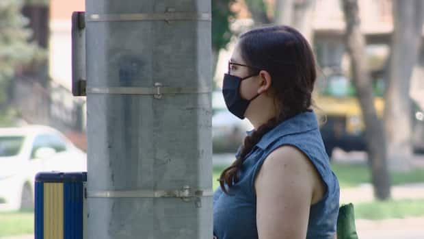 Some Regina and Saskatoon residents are still wearing masks even though the province lifted all public COVID-19 restrictions. (Germain Wilson/CBC - image credit)