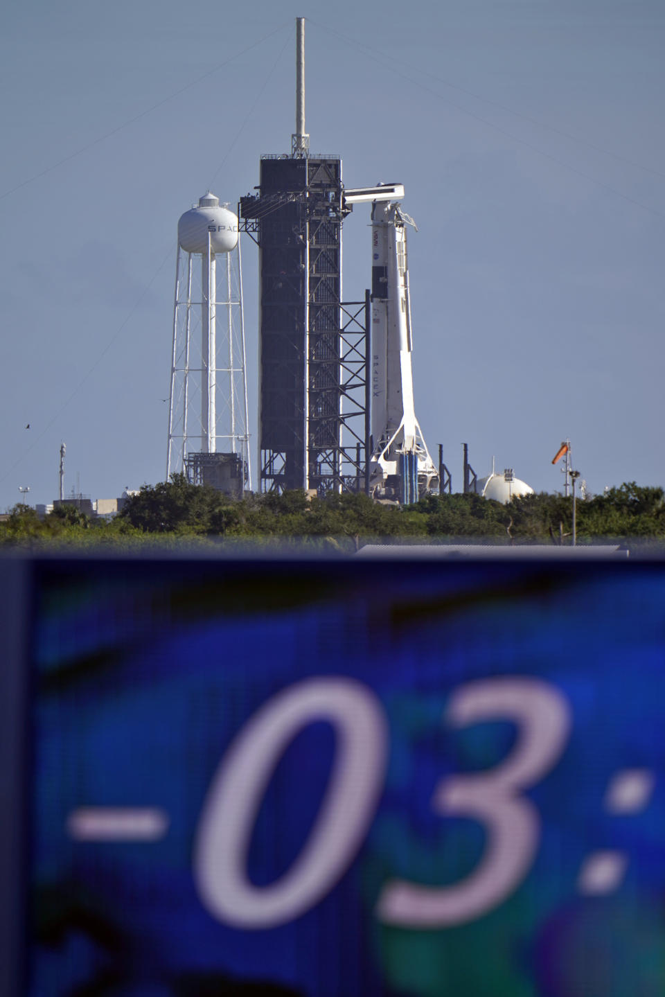 The countdown clock is stopped at a three-hour built in hold as a SpaceX Falcon 9 rocket, with the company's Crew Dragon capsule attached, sits on the launch pad at Launch Complex 39A Sunday, Nov. 15, 2020, at the Kennedy Space Center in Cape Canaveral, Fla. Four astronauts will fly on the SpaceX Crew-1 mission to the International Space Station scheduled for launch on later today. (AP Photo/Chris O'Meara)