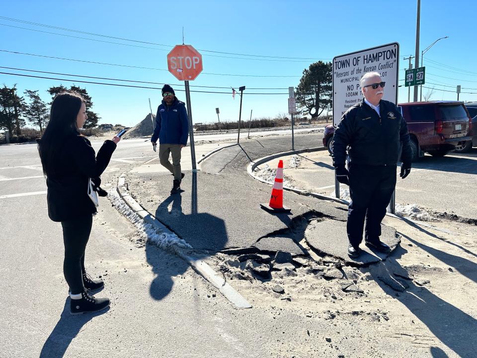 Fire Chief Michael McMahon (right) stands with FEMA worker Vincenza DiMaio at the Veterans of the Korean Conflict municipal parking lot where flood water caused damaged during two storms in January.