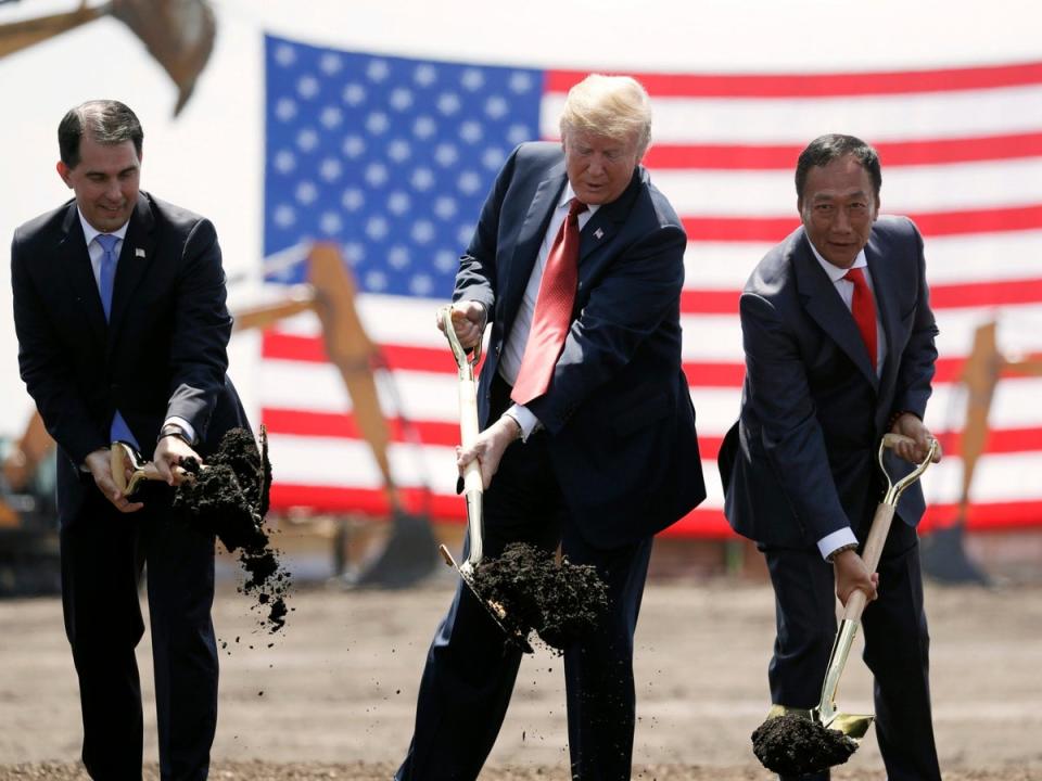 Donald Trump, centre, Wisconsin governor Scott Walker, left, and Foxconn chairman Terry Gou participate in a groundbreaking event for the new company's facility in Mount Pleasant in June 2018 (AP)