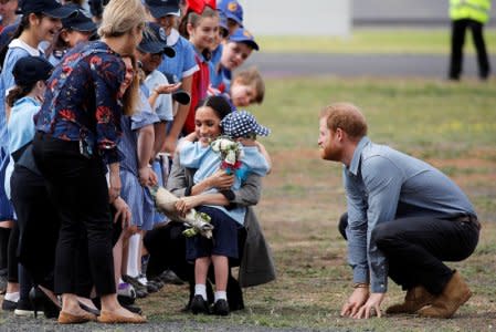 Meghan, Duchess of Sussex, hugs Luke Vincent, 5, after arriving at Dubbo airport, Dubbo, Australia October 17, 2018. REUTERS/Phil Noble