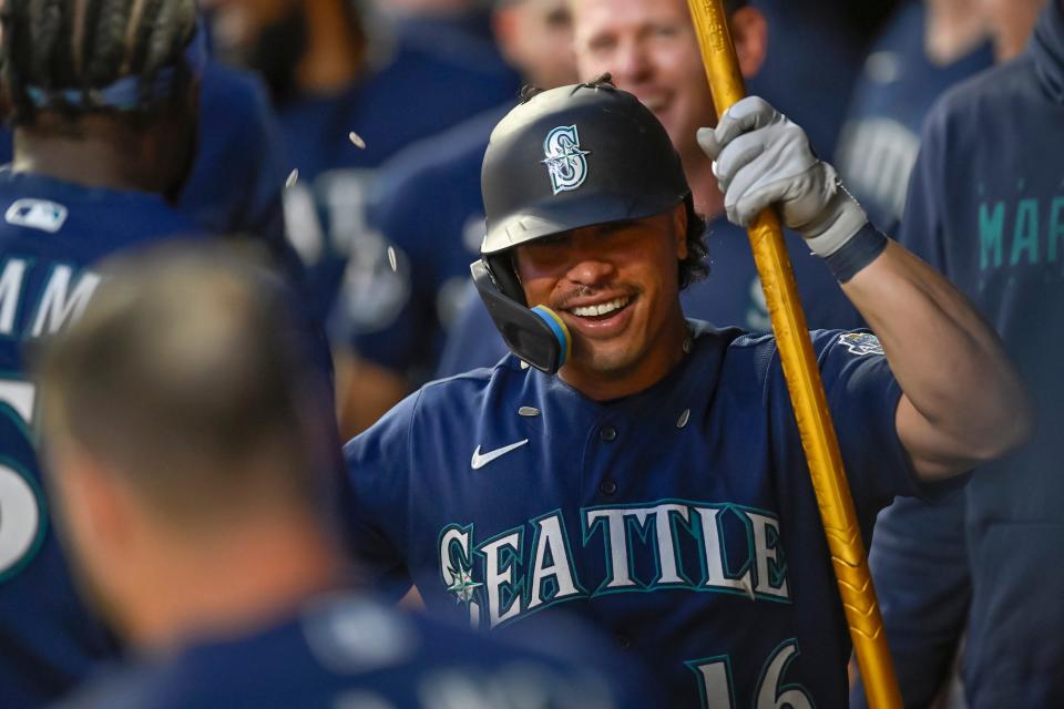 Seattle Mariners infielder Kolten Wong (16) celebrates his pinch-hit two-run home run against the Minnesota Twins during the ninth inning at Target Field.