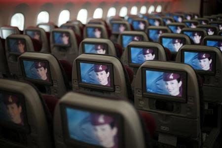 Seats and screens are seen in the economy class cabin of Qatar Airways new Boeing 787 Dreamliner are seen after it arrived on it's inaugural flight to Heathrow Airport, west London December 13, 2012. REUTERS/Andrew Winning