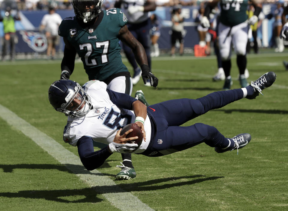 Tennessee Titans quarterback Marcus Mariota (8) dives over the goal line to score a touchdown against the Philadelphia Eagles in the second half of an NFL football game Sunday, Sept. 30, 2018, in Nashville, Tenn. Defending for the Eagles is Malcolm Jenkins (27). (AP Photo/James Kenney)