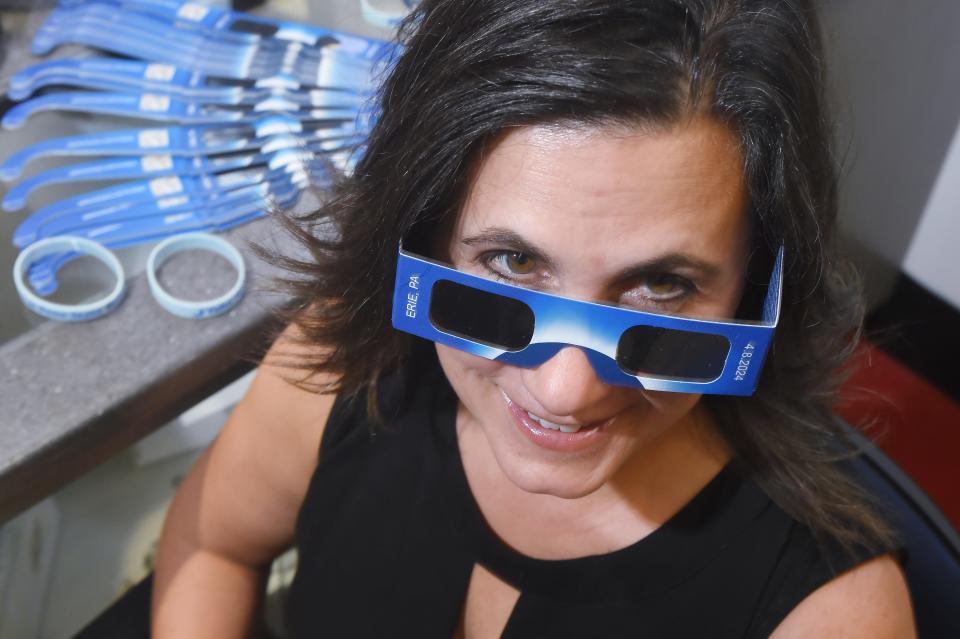 Tracy Halmi, Penn State Behrend Assoc. Teaching Professor of Chemistry and the school's science outreach coordinator, stands near eclipse glasses inside the Yahn Planetarium in Harborcreek Township. Behrend will provide 50,000 pairs of the glasses to area school children to help them view the upcoming April 8 total eclipse.