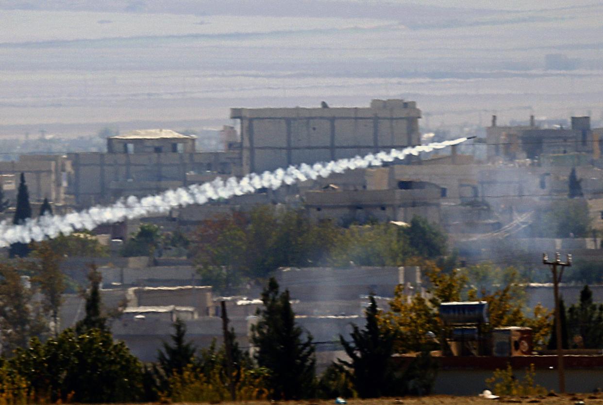 A rocket fired by Isis forces flies from the east to the west side of the Syrian town of Kobani during fighting on 6 November 2014: REUTERS