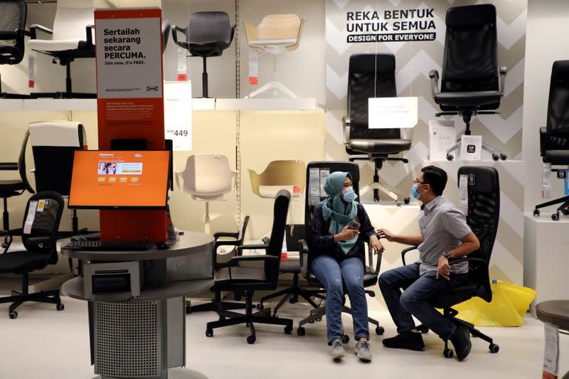 FILE PHOTO: Customers wearing protective masks shop for office furniture at IKEA, amid the coronavirus disease (COVID-19) outbreak in Petaling Jaya