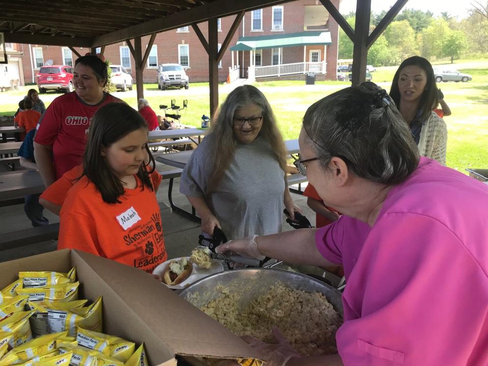 Students in the third grade leadership team program from Sherman Elementary School Friday helped residents at Dayspring Friday at the picnic get their plates to the picnic tables. The annual picnic was sponsored by Doc Stumbo and Sherman Elementary School.