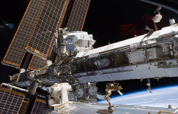 The powerful Alpha Magnetic Spectrometer-2 (AMS) is visible at center left. The blackness of space and Earth's horizon provide the backdrop for the scene, on May 20, 2011 (Flight Day 5 of the STS-134 shuttle mission).