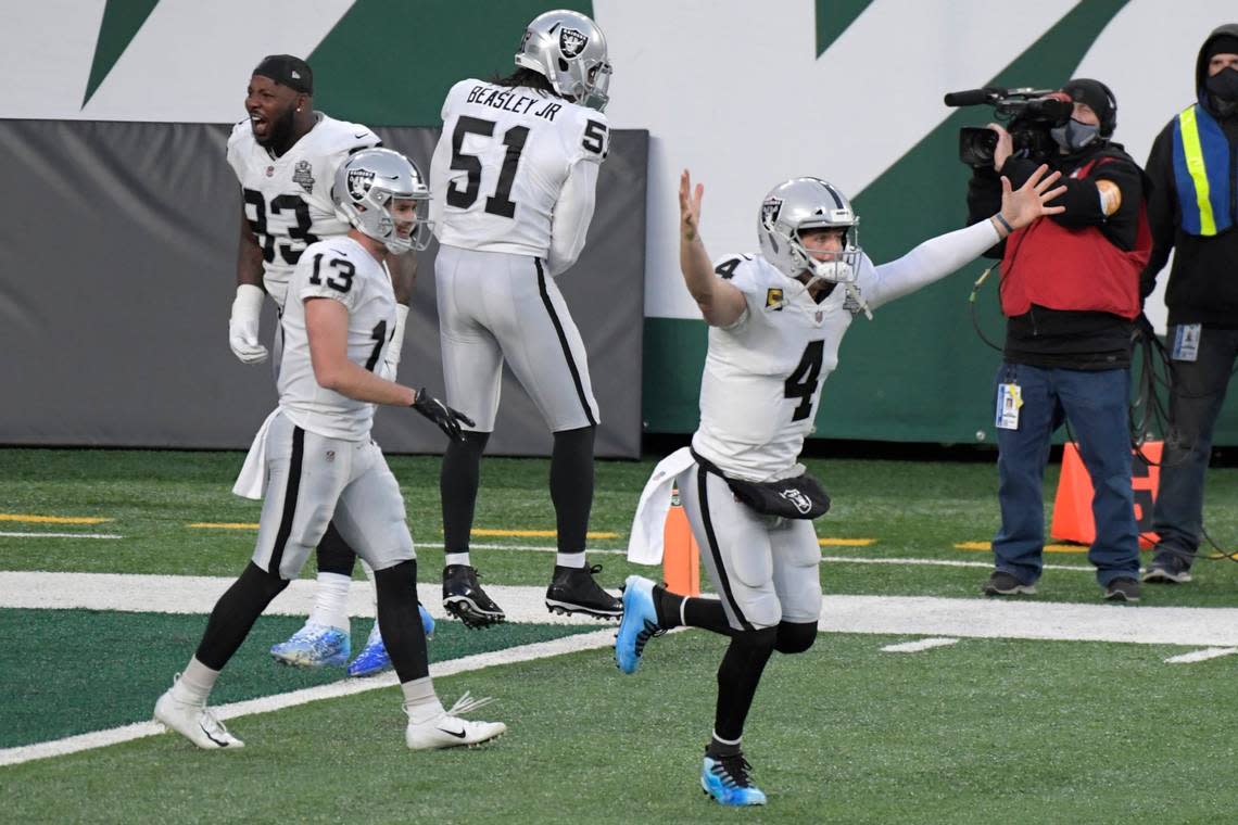 Las Vegas Raiders quarterback Derek Carr, right, celebrates his touchdown pass to Henry Ruggs III during the second half an NFL football game against the New York Jets, Sunday, Dec. 6, 2020, in East Rutherford, N.J.