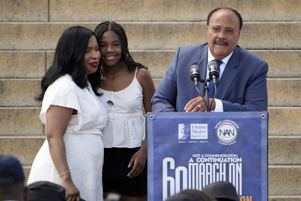 Martin Luther King III, the son of Martin Luther King Jr., right, speaks as he stands with his wife Andrea Waters King, left, and their daughter Yolanda King during the 60th Anniversary of the March on Washington at the Lincoln Memorial in Washington, Saturday, Aug. 26, 2023. (AP Photo/Andrew Harnik)