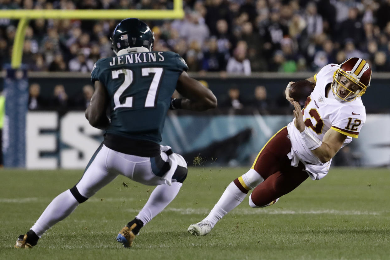 Washington Redskins’ Colt McCoy (12) tries to avoid Philadelphia Eagles’ Malcolm Jenkins (27) but ended up injuring his leg. (AP)