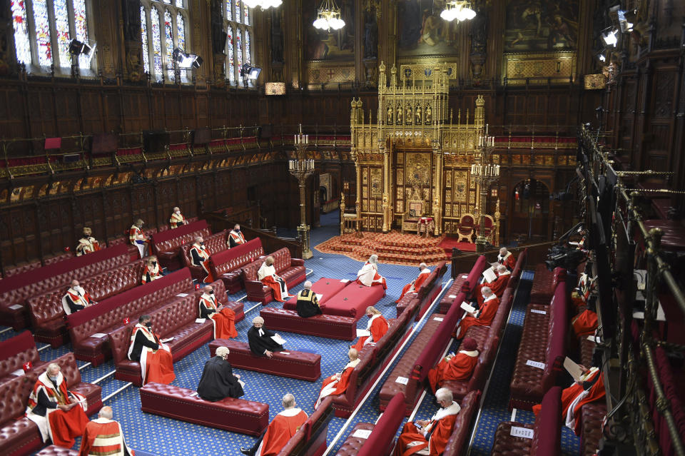 The House of Lords chamber before Britain's Queen Elizabeth II is to deliver a speech at the State Opening of Parliament in the House of Lords at the Palace of Westminster in London, Tuesday May 11, 2021. (Eddie Mulholland/Pool via AP)