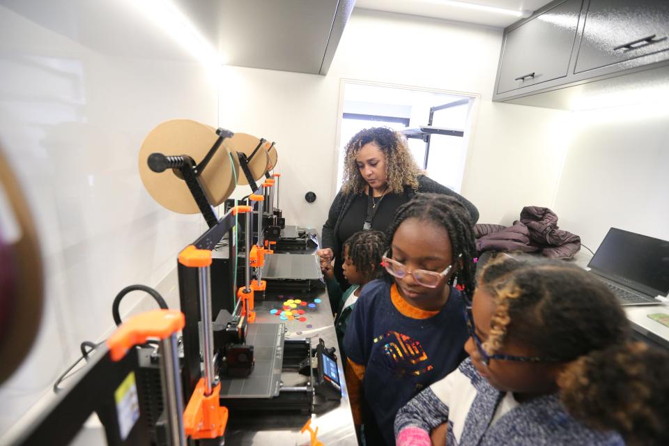 Lucinda Reese, program director, oversees students on the 3D printers Friday, Nov. 3, 2023, at the mobile maker lab that is housed in a custom RV run by the Boys & Girls Clubs of St. Joseph County. The RV There Yet? Great Futures Inventor Center will travel to the Boys & Girls Clubs' 25 affiliate sites in the county and will visit each location once a quarter.