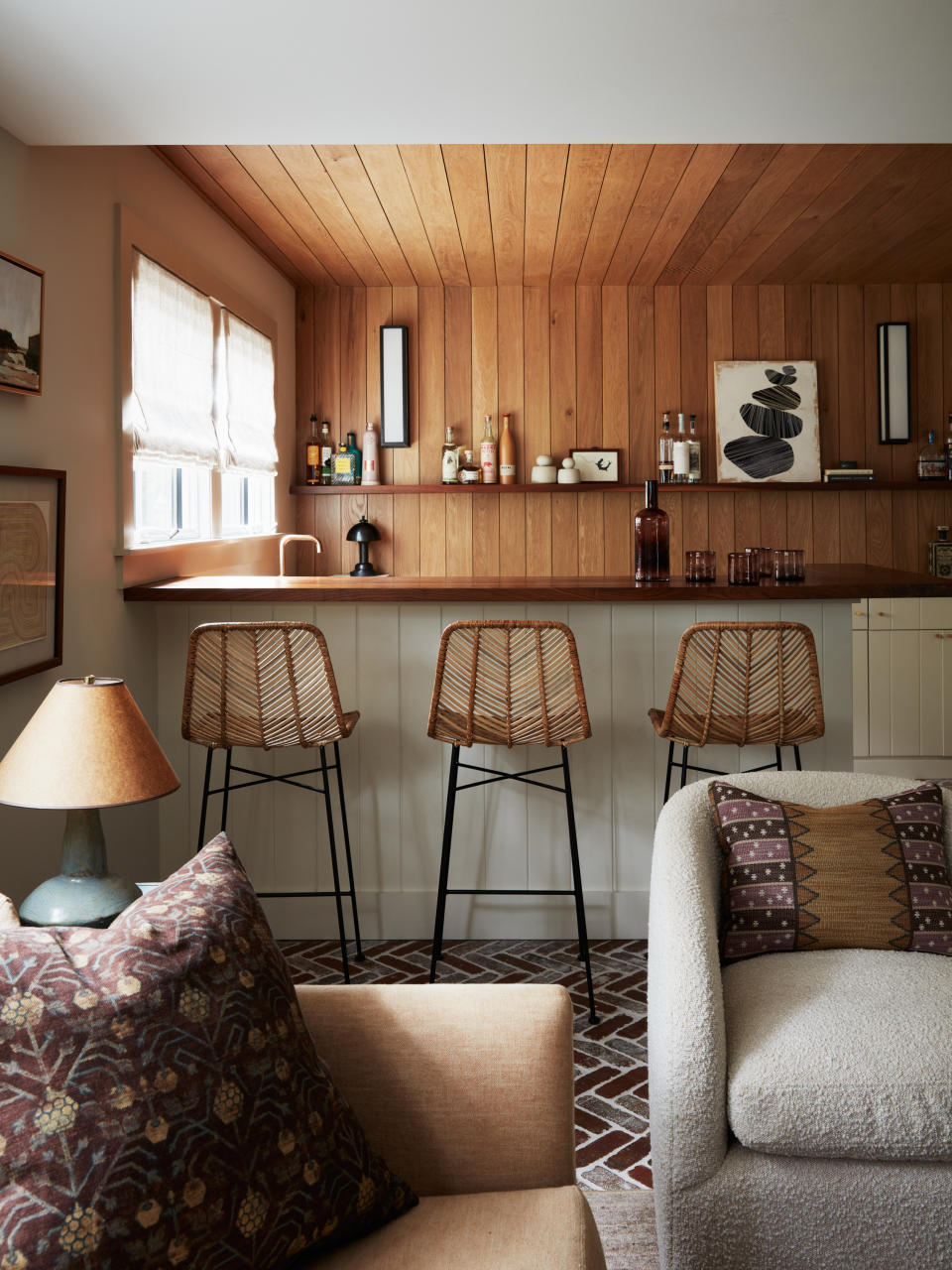 a downstairs lounge with a bar