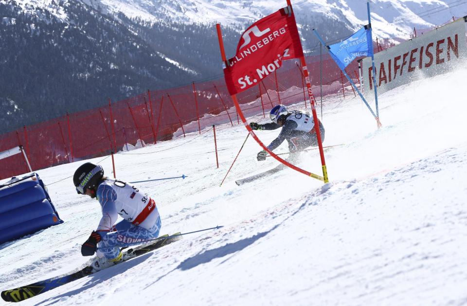 Slovakia's Adam Zampa, left, and France's Alexis Pinturault compete in a parallel race during a team event, at the alpine ski World Championships, in St. Moritz, Switzerland, Tuesday, Feb. 14, 2017. (AP Photo/Alessandro Trovati)