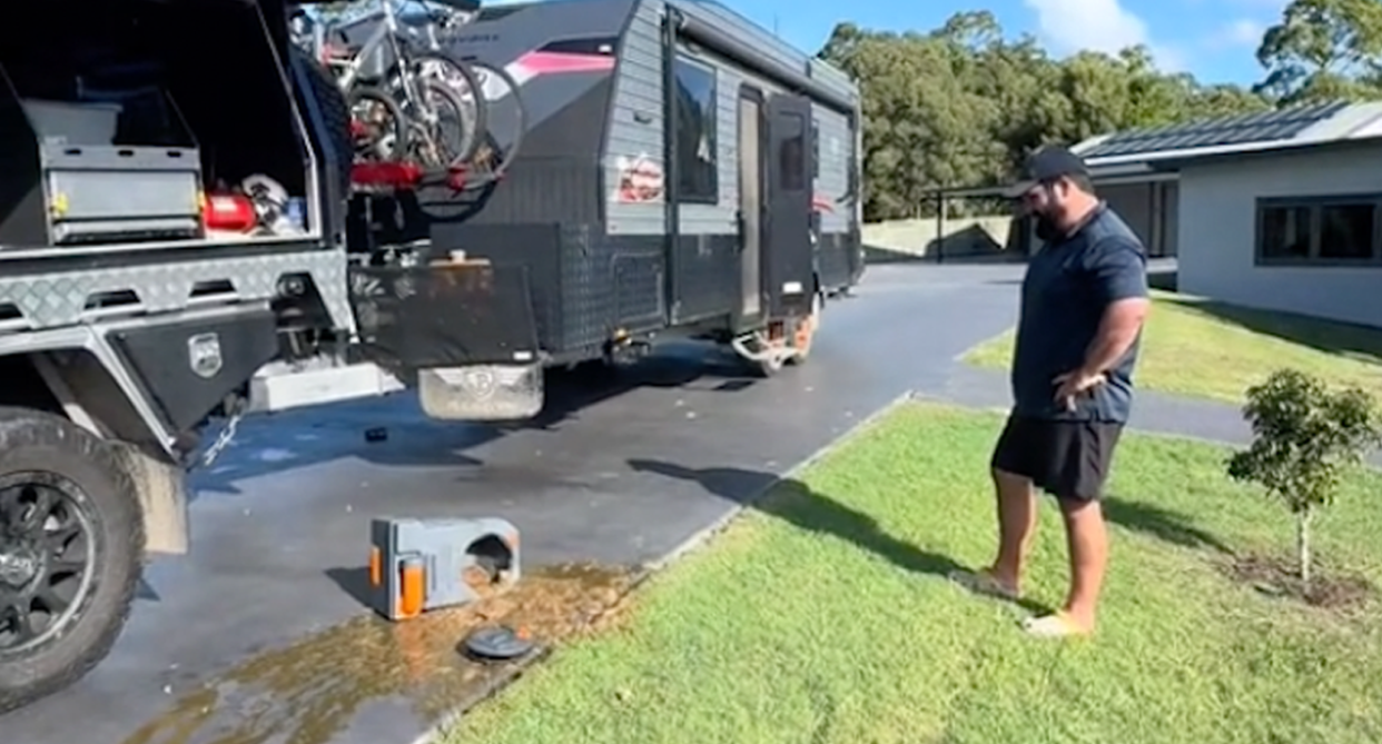 4WD driver Alex Clements stands with his hands on his hips looking at the contents strewn across his Gold Coast driveway. 