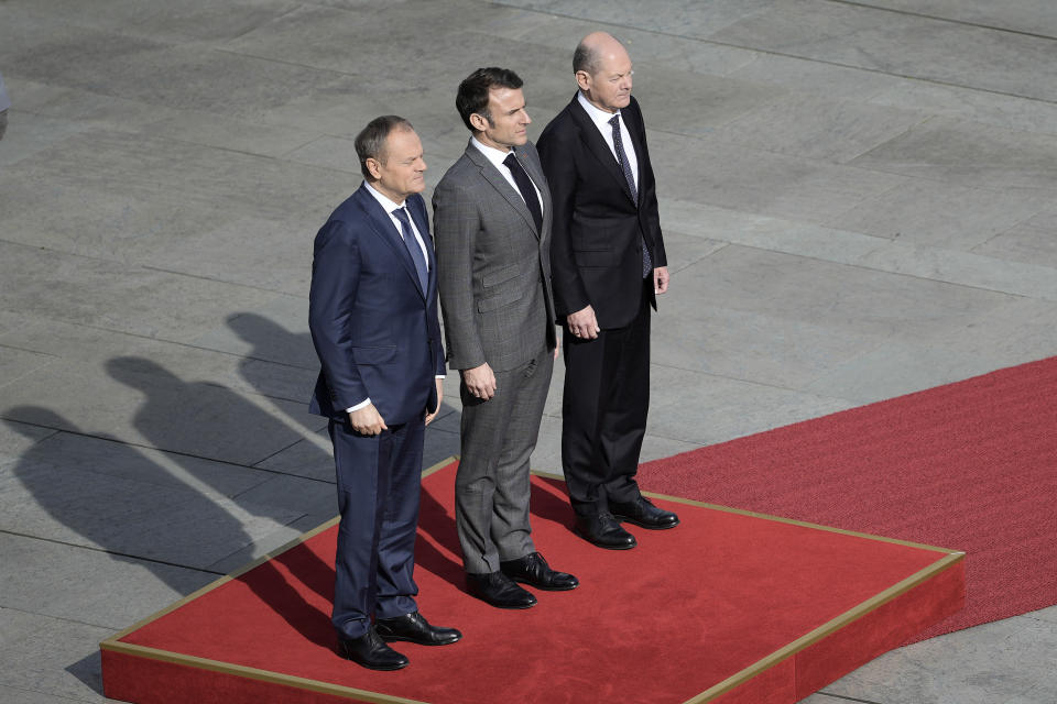 German Chancellor Olaf Scholz, French President Emmanuel Macron and Poland's Prime Minister Donald Tusk, from right, standing at a red carpet for military honors in Berlin, Germany, Friday, March 15, 2024. German Chancellor Olaf Scholz, France's President Emmanuel Macron and Poland's Prime Minister Donald Tusk meet in Berlin for the so-called Weimar Triangle talks. (AP Photo/Markus Schreiber)