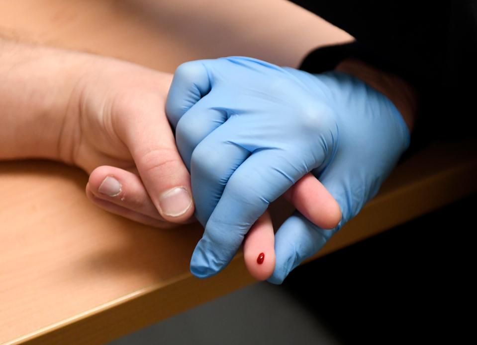 Alex Driggars' finger is pricked to see his iron count before he gives blood, Wednesday, Jan. 24, 2024, at Vitalant.