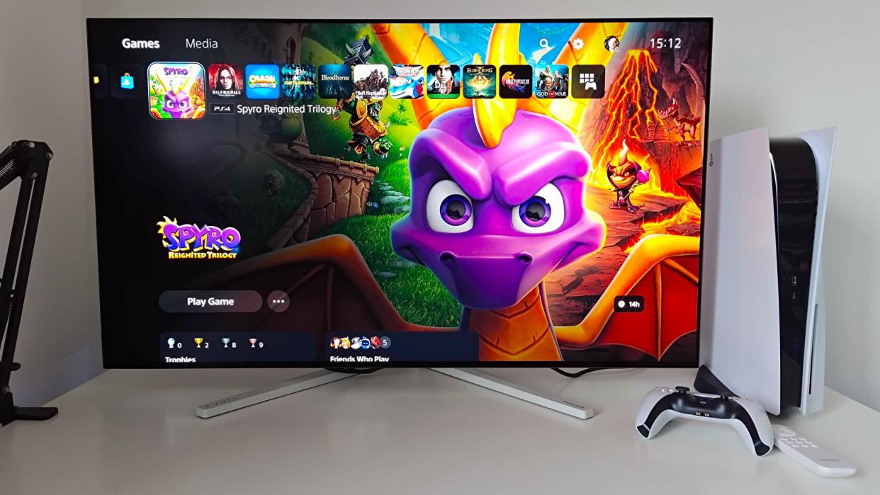  Philips Evnia 42M2N8900 monitor with PS5 menu on screen and Spyro the Dragon Reignited Trilogy art . 