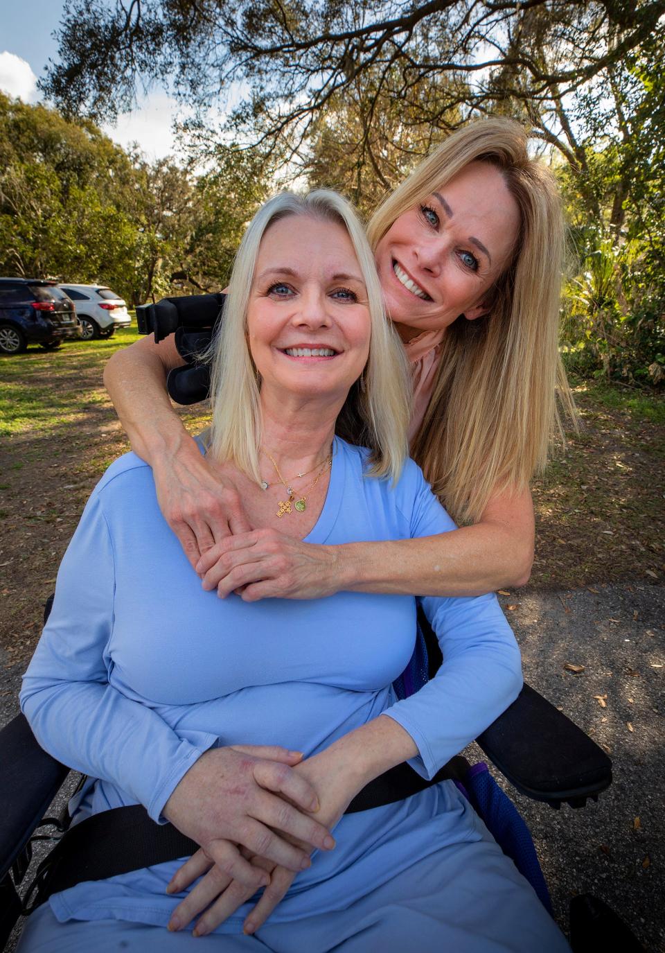 Longtime friend Laura Carpenter visits Laura Pinner at her home in South Lakeland. Pinner, 53, was diagnosed two years ago with ALS. Despite the loss of most physical abilities, she tries to remain positive and welcomes frequent visits from friends.