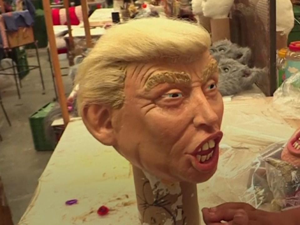 a hyper realistic Donald Trump Mask on a stand