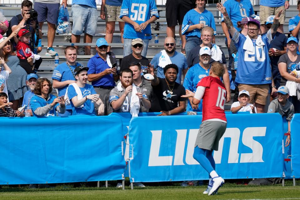 Lions quarterback Jared Goff throws a football to fans after training camp practice in Allen Park on Saturday, July 31, 2021.