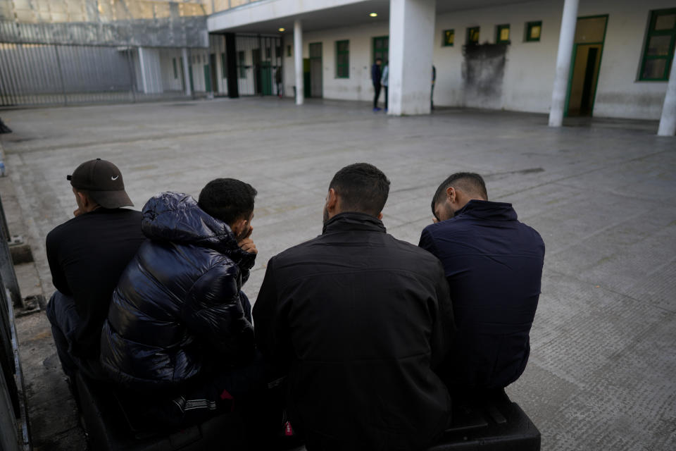 Detainees gather in an open area of the Ponte Galeria center, one of the facilities created in Italy to hold migrants ahead of their repatriation, as they are considered ineligible for refugee status or international protection, in Rome, Tuesday, March 19, 2024. (AP Photo/Andrew Medichini)