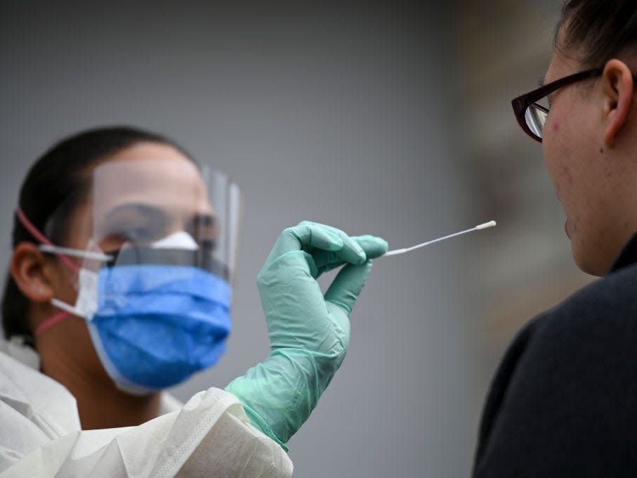 A medical assistant administers a COVID-19 test in Fridley, Minnesota.