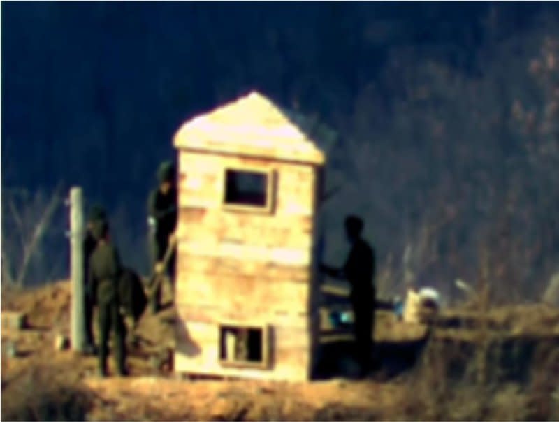 North Korean soldiers are spotted painting a guard post inside the Demilitarized Zone separating the two Koreas on Friday. Photo courtesy of South Korean Defense Ministry/Yonhap