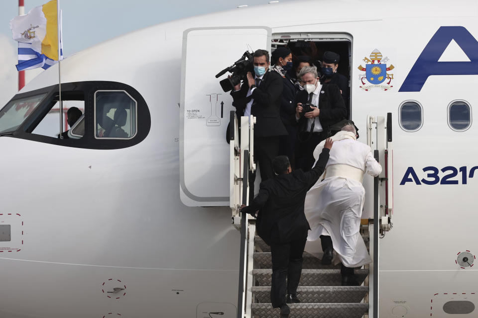 Pope Francis boards an aircraft departing from Eleftherios Venizelos International Airport in Athens, Greece, Monday, Dec. 6, 2021. Francis' five-day trip to Cyprus and Greece has been dominated by the migrant issue and Francis' call for European countries to stop building walls, stoking fears and shutting out "those in greater need who knock at our door." (AP Photo/Yorgos Karahalis)