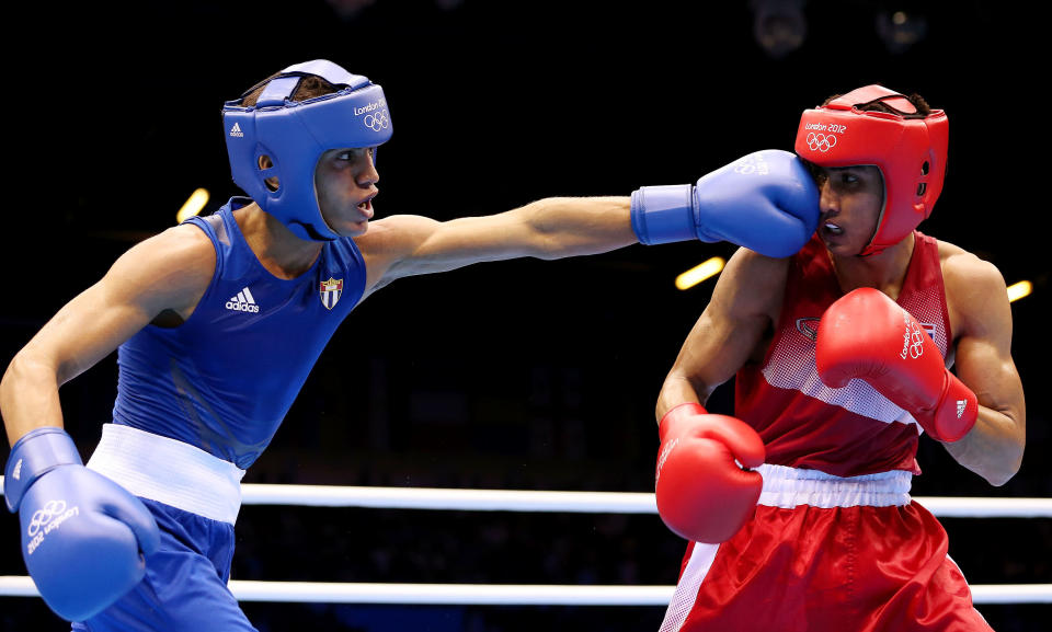 LONDON, ENGLAND - AUGUST 03: Robeisy Ramirez Carrazana of Cuba (L) in action with Chatchai Butdee of Thailand during the Men's Fly (52kg) Boxing on Day 7 of the London 2012 Olympic Games at ExCeL on August 3, 2012 in London, England. (Photo by Scott Heavey/Getty Images)