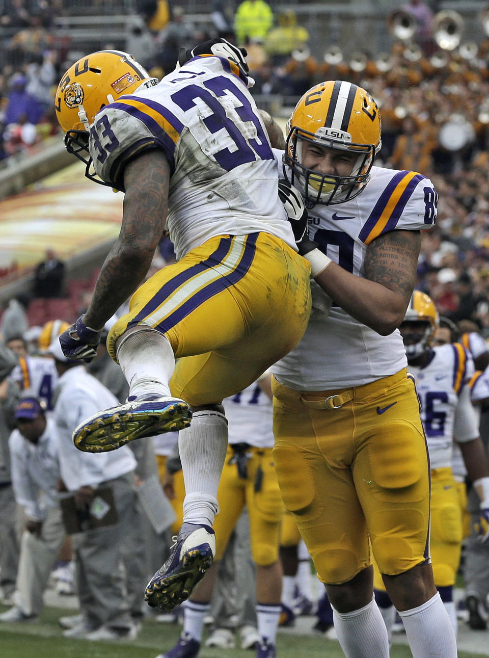 LSU running back Jeremy Hill (33) celebrates with tight end DeSean Smith (89) after Hill scored on a 14-yard touchdown run against Iowa during the second quarter of the Outback Bowl NCAA college football game Wednesday, Jan. 1, 2014, in Tampa, Fla. (AP Photo/Chris O'Meara)