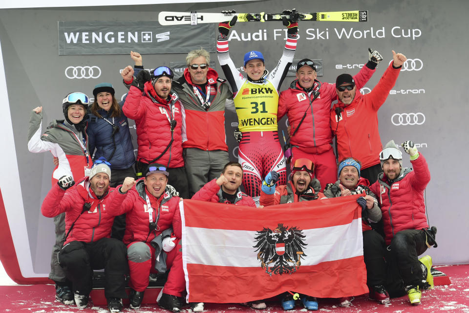 First placed Austria's Matthias Mayer, background center, celebrates with teammates at the end of an alpine ski, men's World Cup combined in Wengen, Switzerland, Friday, Jan. 17, 2020. (AP Photo/Marco Tacca)