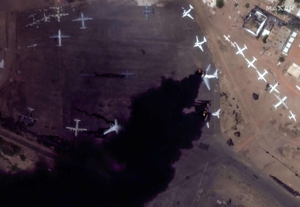 This satellite image provided by Maxar Technologies shows two burning planes at Khartoum International Airport, Sudan, Sunday April 16, 2023. The Sudanese military and a powerful paramilitary group are battling for control of the chaos-stricken nation for a second day. (Satellite image ©2023 Maxar Technologies via AP)