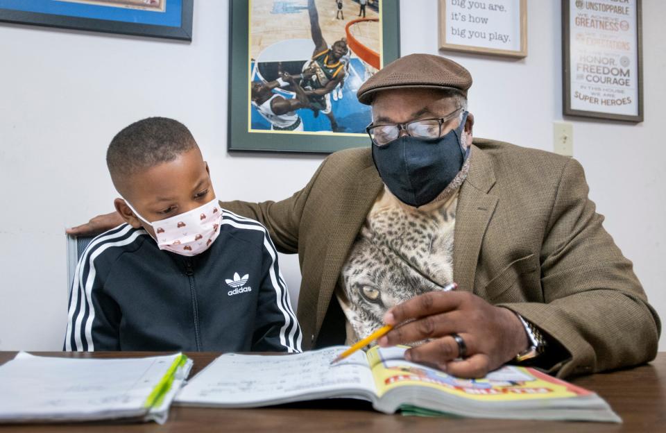 Benny Washington, right, helps St. Paul Catholic School 3rd grader Jaylen Mathis, 8, with a math problem during the James B. Washington Education and Sports, Inc. tutorial program in Pensacola on Tuesday, March 2, 2021.