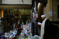 A Shi'ite cleric reads a book at a library in Najaf, south of Baghdad, Iraq, August 12, 2017. REUTERS/Abdullah Dhiaa Al-deen