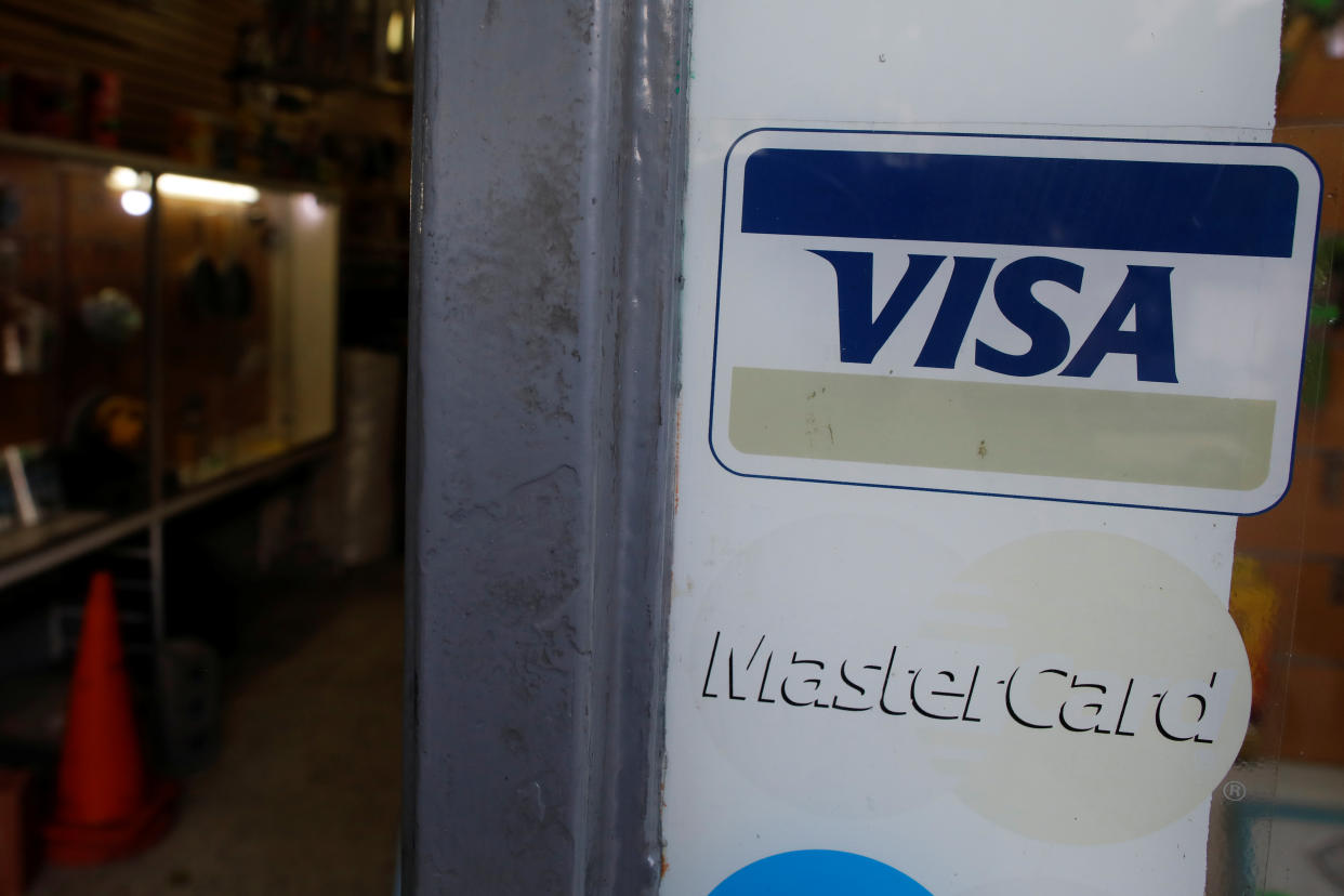 Stickers with the corporate logos of Visa and MasterCard are seen at the entrance of a hardware store in Caracas, Venezuela March 14, 2019. REUTERS/Carlos Garcia Rawlins